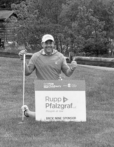 David with sponsorship sign at golf tourney
